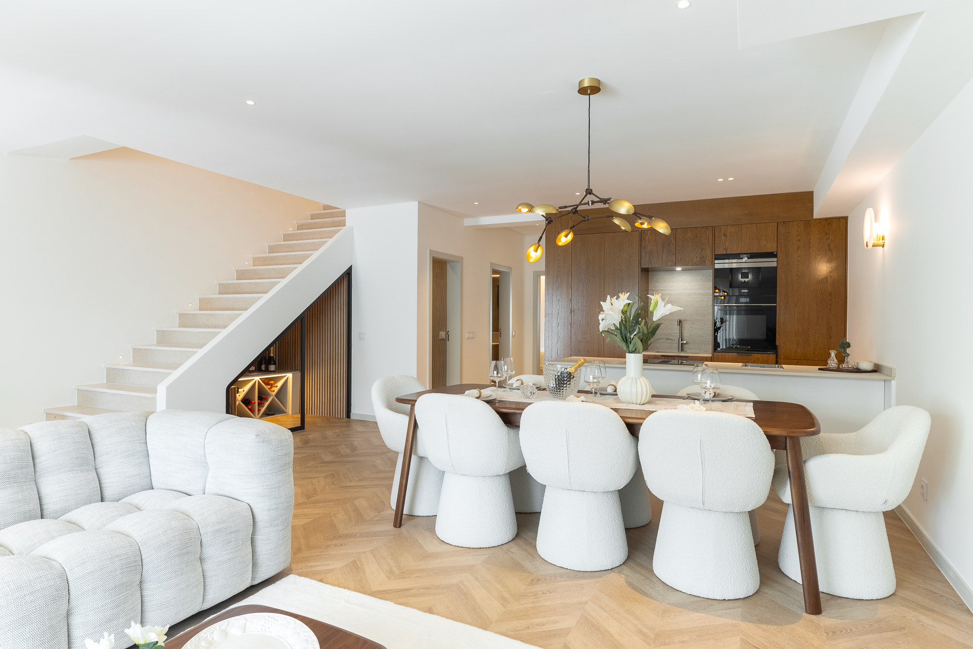 Golden Triangle Property Pitfalls illustrated through a refined Algarve interior with contemporary dining, bespoke joinery, and a calm, modern finish.